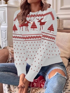 Detail view of festive white and red knit sweater featuring reindeer and holiday patterns