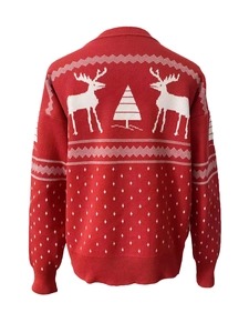 Detail of red Christmas knit sweater with white reindeer and snowflake patterns