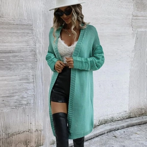 Detailed close-up of hollow knit patterns on mint green long cardigan sleeves