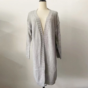Close-up of light gray knitted cardigan featuring chunky texture and hollow out sleeve details