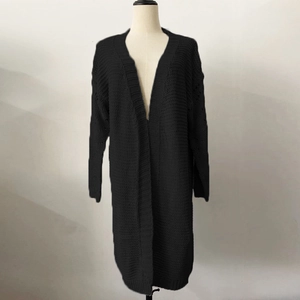 Detail of black long-line chunky knit cardigan showing thick texture and loose fit style