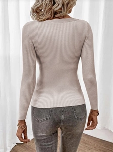Close-up back view of a slim-fit ribbed knit sweater in beige with a clean crew neckline