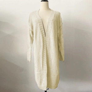 Close-up of cream long knit cardigan showing chunky knit texture and ribbed trims