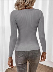 Macro shot of grey ribbed knit texture and slim fit design on the back of the sweater