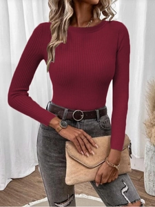 Detailed view of burgundy ribbed knit texture on long sleeve slim fit crewneck sweater