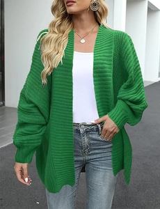 Outdoor street style view of loose fit emerald green chunky knit cardigan for women