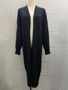 Close-up of black longline knit cardigan showing warm texture and long sleeves