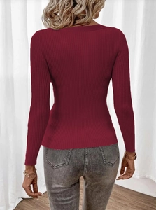 Close-up of the wine red ribbed knit texture and slim fit design on women's sweater