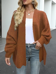 Detail of chunky knit texture on loose caramel cardigan with drop shoulder seams