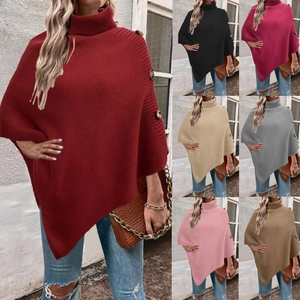 Detail of high neck knitted poncho wrap with decorative side buttons in various colors