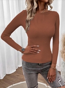 Close-up of rust brown ribbed knit texture on a slim-fit crewneck sweater