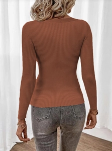 Detail view of caramel brown knit sweater featuring vertical ribbing and a slim fit design