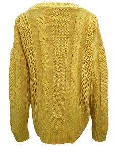 Detail view of bright yellow chunky cable knit sweater back with ribbed edges