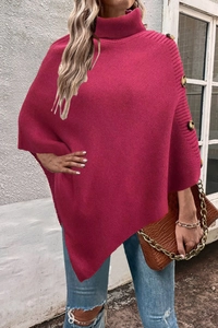 Detail showing knit texture and decorative buttons on magenta high neck poncho wrap