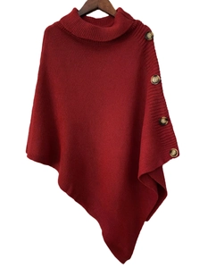 Detailed view of dark red knit poncho featuring high roll-neck and vintage wood buttons