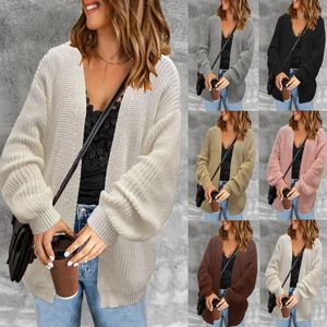 Detail view of knit cardigan sweater featuring lantern sleeves and chunky texture in multiple colors