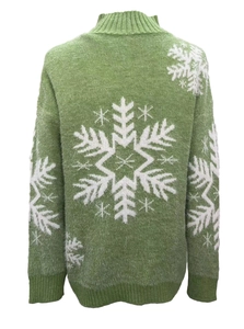 Detail view of green Christmas sweater featuring fuzzy knit fabric and white snowflake pattern