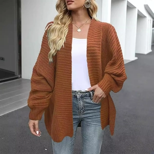 Women's oversized chunky knit cardigan sweater in rust red with long lantern sleeves