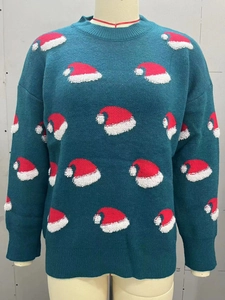 Detail of Christmas tree green knit sweater featuring festive red and white hat patterns