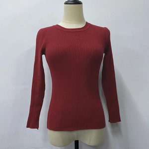 Detail of red crew neck long sleeve sweater showing vertical ribbed knit texture and fit