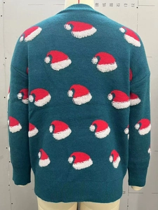 Detail of Christmas sweater with festive red and white hat patterns on blue knit fabric