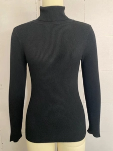 Detail view of black high neck ribbed knit sweater with elegant texture and slim fit