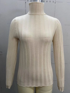 Detailed close-up of beige high neck knit sweater featuring vertical ribbed texture