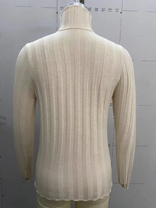 Detail of the high collar and ribbed knit texture on this cream white women's sweater