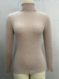 Detail of high neck beige knit sweater featuring premium vertical ribbed texture and slim fit