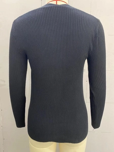 Close-up of the black ribbed knit fabric and slim fit back design of this long sleeve top