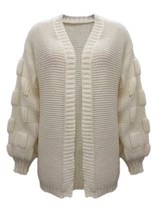 Detail of creamy white knitted cardigan featuring textured bubble sleeves and ribbed cuffs