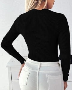 Close-up of the ribbed texture and slim fit design of this black long sleeve knit top