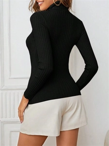 Side view of black ribbed knit turtleneck sweater featuring a slim fit long sleeve design