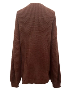 Close-up of dark brown chunky knit sweater showing vertical texture and drop shoulder design