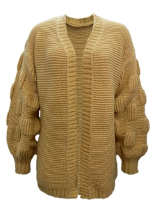 Detail of yellow chunky knit cardigan featuring 3D bubble sleeve knit texture