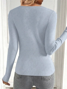 Detail view of the back of a slim fit light blue ribbed knit sweater for women
