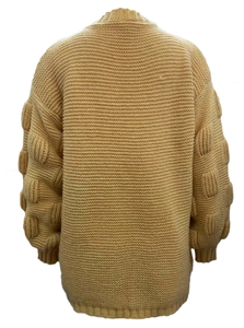 Detail of chunky mustard knit cardigan featuring 3D popcorn textured lantern sleeves