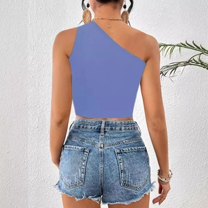 Back view of a navy blue one-shoulder rib-knit crop top styled with denim shorts