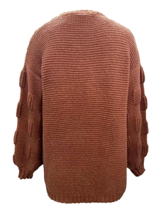 Detail view of rust red oversized cardigan with unique bubble sleeve knit texture