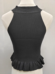 Close-up of black sleeveless knit top with ruffled hem and ribbed texture back view