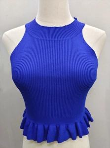 Close-up of dark blue sleeveless knit crop top with ruffled hem and ribbed texture