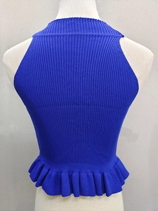 Macro detail of royal blue ribbed knit texture and ruffled hem on sleeveless halter top