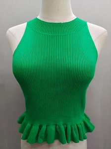 Detail of green ribbed knit sleeveless top featuring a ruffled hem and high neckline