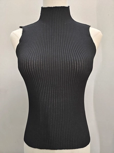 Detail view of the black ribbed knit fabric and high neckline on the sleeveless top