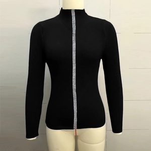 Detail of black ribbed knit sweater featuring a vertical black and white gingham ribbon