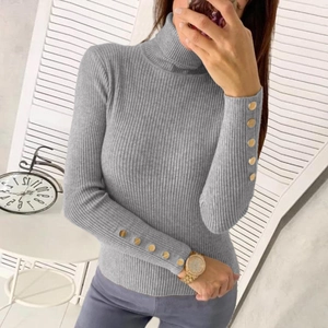 Detail of grey ribbed knit sweater featuring gold button accents on the cuffs