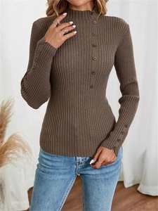 Detail of brown ribbed knit sweater with decorative buttons on collar and cuffs