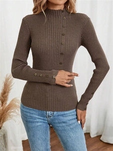 Detail view of the ribbed knit texture and button accents on the brown sweater sleeve