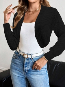 Detail of black long sleeve cropped knit cardigan showing ribbed texture and open front