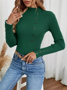 Detail of dark green ribbed knit sweater featuring decorative buttons on cuffs and collar